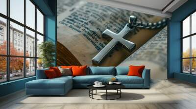 A silver cross pendant lying on an open Bible, symbolizing the connection between faith and scripture Wall mural