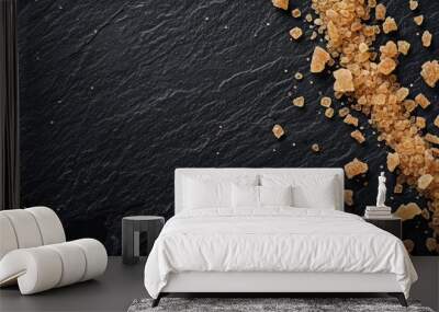 Black slate background with brown cane sugar Wall mural