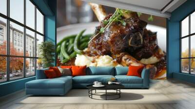 Close-up of a plate of braised lamb shank with a side of mashed potatoes and green beans Wall mural