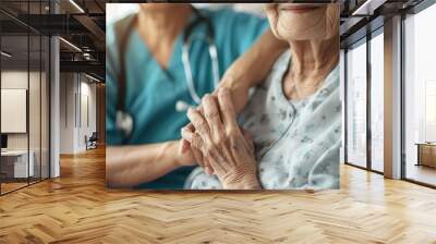 Elderly female hand holding hand of young caregiver at nursing home.Geriatric doctor or geriatrician concept. Doctor physician hand on happy elderly senior patient to comfort in hospital examination Wall mural