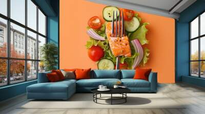 fork with food on it: delicious fillet salmon, cucumber, onion, green salad on orange background. co Wall mural