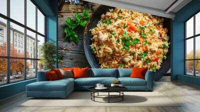 Fried rice with chicken. Prepared and served in a wok. Natural wood in the background. Top view. Wall mural