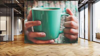 Hands holding a coffee mug while scrolling through emails on a smartphone, creating a seamless integration of work and relaxation. Wall mural