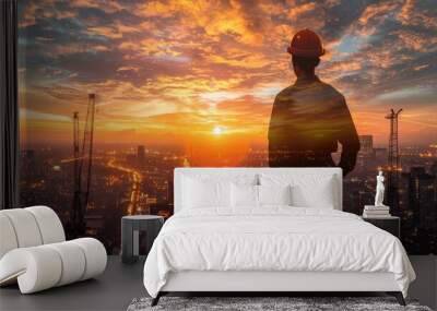 The double exposure image of the engineer standing back during sunrise overlay with cityscape image. The concept of engineering, construction, city life and future Wall mural