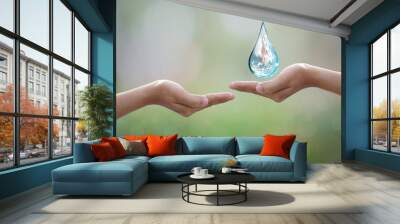 World Environment Day.human hand protecting water drop with sunlight on green nature background. Wall mural