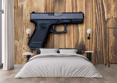  gun standing on wooden table Wall mural