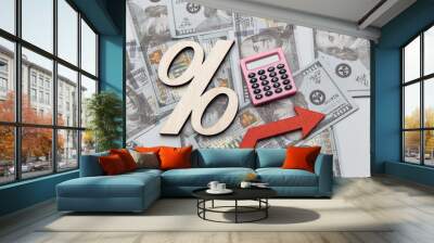 Calculator, arrow up and symbol of percent on dollar banknotes. Investment concept Wall mural