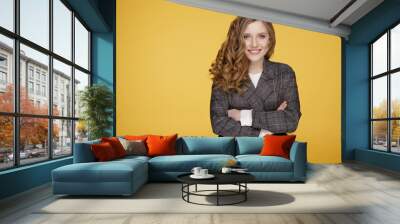 Closeup portrait of pretty yong woman with bright makeup in a gray jacket in a studio isolated over the yellow background. Wall mural