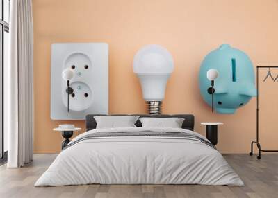 LED light bulb, power socket and blue piggy bank. Power energy economy concept. Wall mural