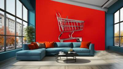 Shopping cart isolated on red Wall mural