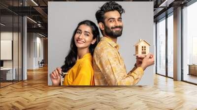 Happy Indian couple buying a house, Concept photo. Real estate. Wall mural