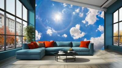 Vivid blue sky with white cloud and sun halo  Wall mural