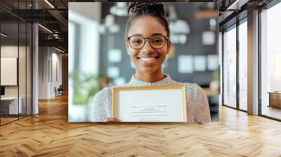 Professional in an office smiling while looking at a framed Dream Job Achieved certificate, career achievement, professional success Wall mural