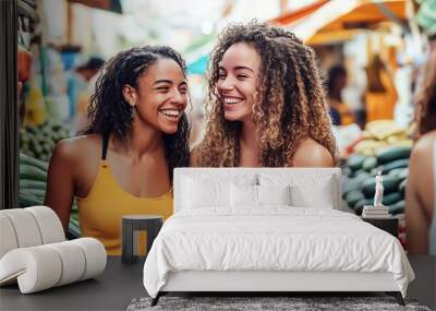 Two women happily shop together, exploring fresh produce and goods at a bustling market, embodying the joy of shared experiences Wall mural