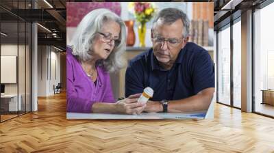 A senior aged couple reading the label on a prescription bottle Wall mural