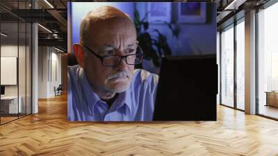 close up of serious older man reading off his computer Wall mural