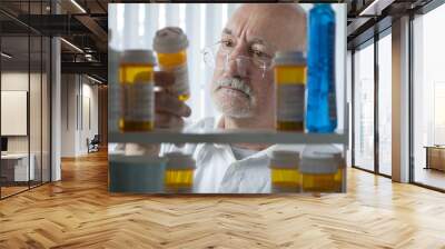 man reaching for prescription form medicine cabinet Wall mural