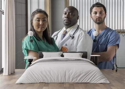 portrait of a proud asian female nurse, caucasian male nurse, and african american doctor Wall mural