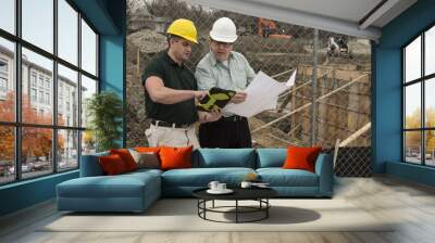 two workers on a construction site using a tablet Wall mural