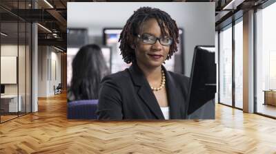 Young black professional woman working on computer at the office Wall mural