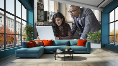 young professionals working together in front of a computer Wall mural