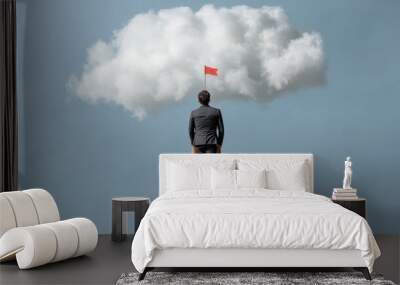 Business success concept: man on ladder reaching for cloud ambition Wall mural