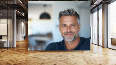 Serene middle-aged man with soft smile in modern home interior for lifestyle and wellbeing concepts Wall mural