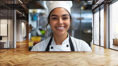 Smiling chef in a professional kitchen setting for culinary industry and cooking enthusiasts Wall mural