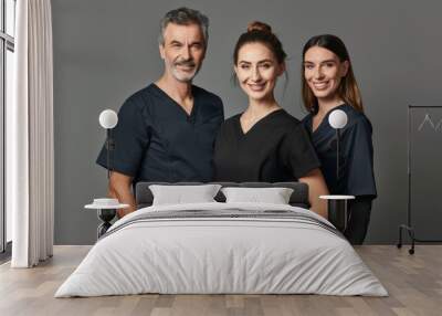 A man and two women in professional scrubs stand together, exuding confidence and professionalism as part of a dental team portrait hyper realistic  Wall mural