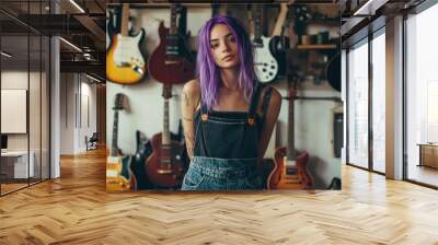 A young, gen z female entrepreneur with an unconventional style and purple hair stands confidently in her creative workshop or guitar shop, showcasing individuality and a spirit of nonconformity. Wall mural