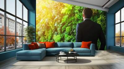 Businessman planning eco friendly esg initiative for sustainable future ecology with chart display Wall mural