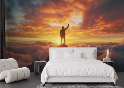 Businessman standing on top of a mountain hand up showing reward receiving for business success achievement at sunset cloud sky Wall mural