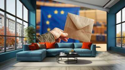 European Union parliament election, closeup on hand holding envelope over EU flag voting box. Wall mural