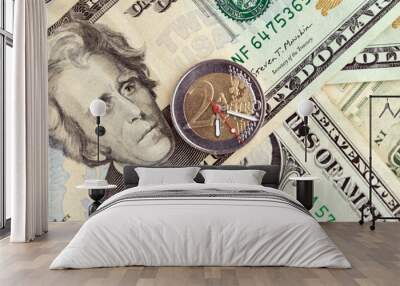 exchange rate: 2 euro coin with hour hands on a pile of dollars, short focus, close Wall mural