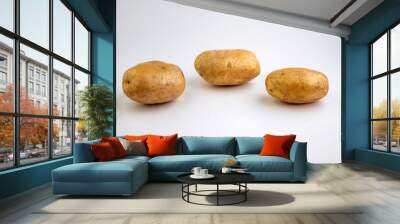 vegan diet: fresh raw organic potatoes, on white, short focus Wall mural