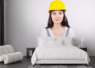 Proud serious young woman architect or engineer with arms crossed as professional building supervisor concept isolated on white background Wall mural