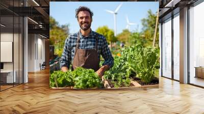 Eco Friendly Gardener Tending to Vegetable Beds in Sustainable Eco Village with Wind Turbines Wall mural