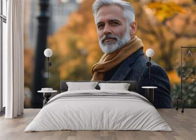 Elegant Silver Haired Man Strolling Through Autumn Park in Luxurious Cashmere Attire Wall mural