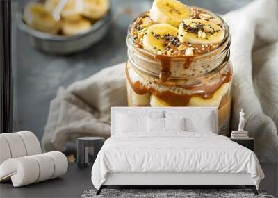 Healthy Breakfast Layered Overnight Oats in Glass Jar with Chia Seeds and Banana Wall mural