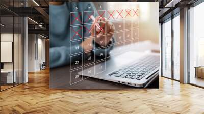 Business people use pen to write crossed-out online calendars and write a message on empty notebook paper while using a laptop to text messages, desktop view, Scheduling of meetings and appointments. Wall mural