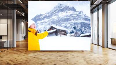 Grindelwald Switzerland top of Europe, Asian woman wearing yellow coat.She is feel Very happy on vacation in the mountains Background.travel trip  Snowy winter on Mount Grindelwald in Switzerland, Wall mural