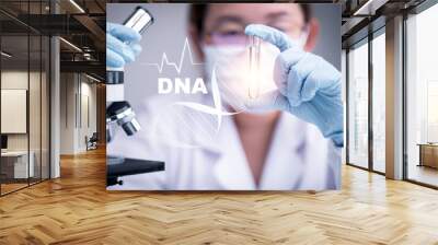 research and developement concept lab scientist biotechnologist holding glass ampoule phial with DNA strand, molecule of two polynucleotide chains forming double helix carrying  Wall mural