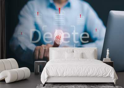 The programmer's hand is tapping on the file icon under the concept of data deletion. The concept  technology and document management.data deletion and removal Wall mural