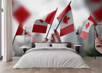 A group of people holding small flags of the Canada in their hands Wall mural