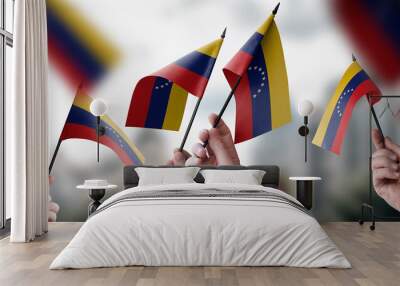 A group of people holding small flags of the Venezuela in their hands Wall mural