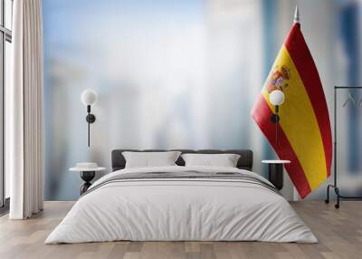 A small flag of Spain on the background of a blurred background Wall mural