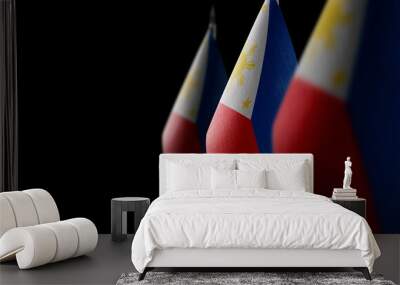 Small national flags of the Philippines on a black background Wall mural