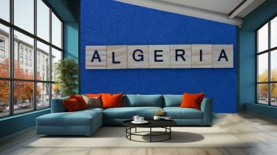 name of the country of algeria from the word from gray wooden letters on a blue table Wall mural