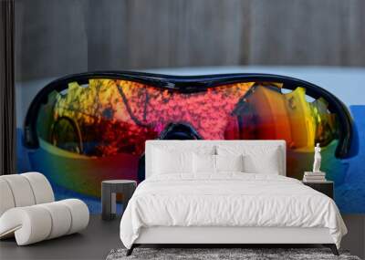 one colored sunglasses lie on a blue table Wall mural