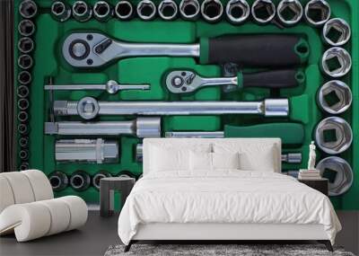 set of gray iron tools in a green open  plastic box Wall mural